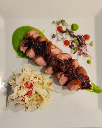 Crispy duck with peach Hoisin Sriracha sauce and Asian slaw